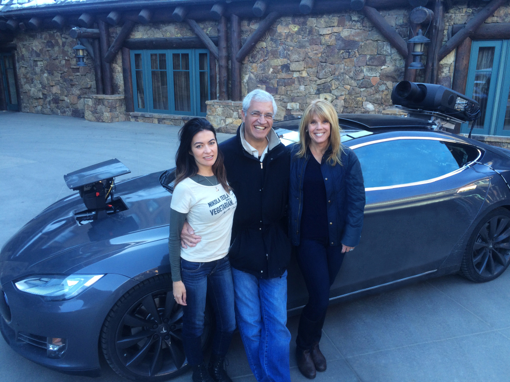 Leilani Münter, Louis Psihoyos and Laura Turner Seydel standing by a one-of-a-kind Tesla made in partnership with Elon Musk for “Racing Extinction.” Photo credit: Laura Seydel