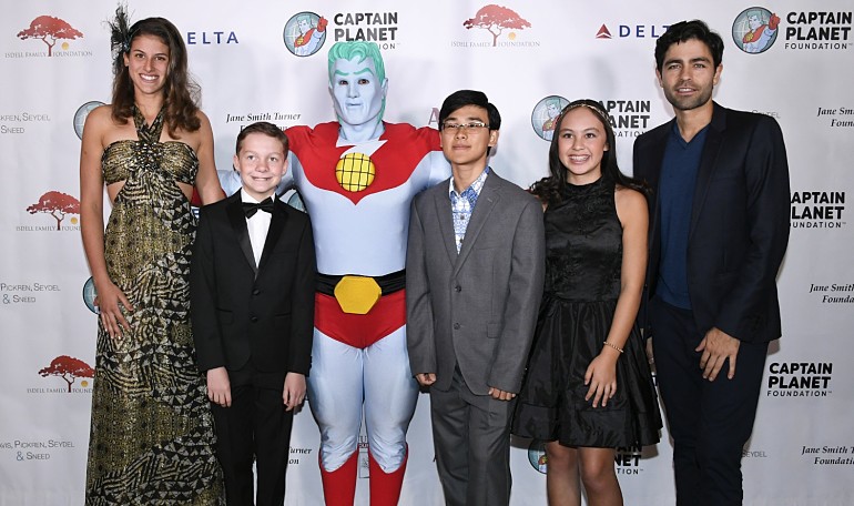 Teenage environmentalists posing with Captain Planet are from left, Steff McDermot, Robbie Bond, Dyson Chee, Chloe Mei Espinosa, as well as actor/environmentalist Adrian Grenier, right, at the Captain Planet Foundation's annual gala on Friday, Dec. 7, 2018, in Atlanta. (John Amis/AP Images for The Captain Planet Foundation)